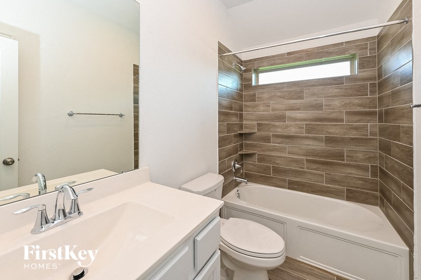 a bathroom with a sink toilet and a bath tub