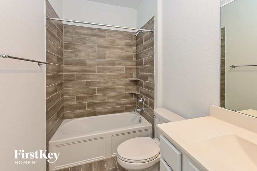 a bathroom with a tub and a sink and a toilet