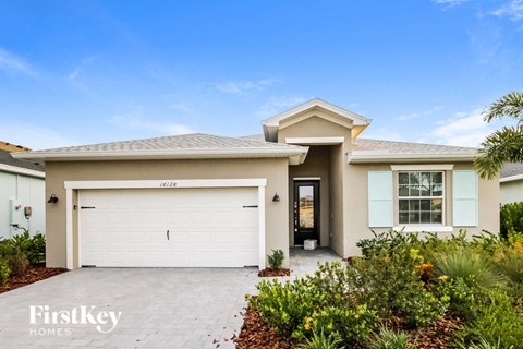 a house with a white garage door and a driveway