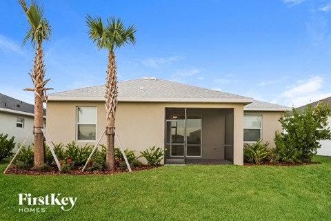 a home with two palm trees in front of it