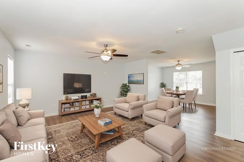 A living room with a brown coffee table and a white couch.