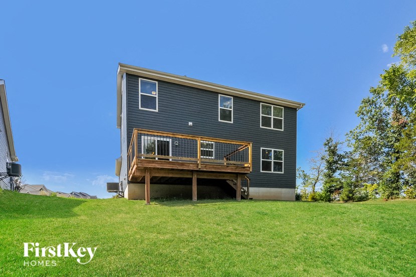 A two-story house with a balcony on the upper floor.