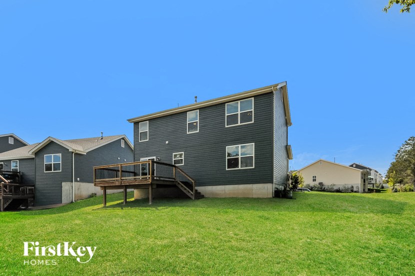 A house with a deck in the backyard.