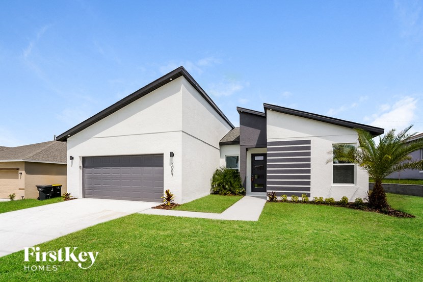 A modern two-story house with a garage is showcased in the image.