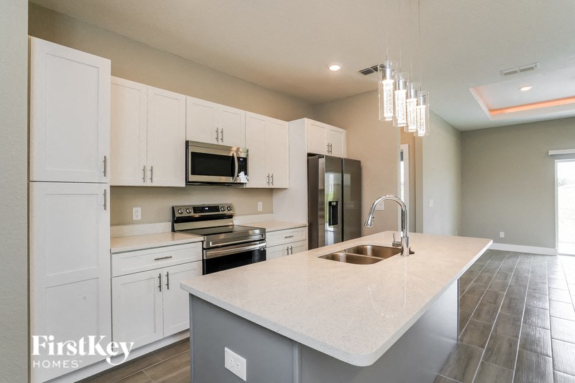 A kitchen with a large island and a sink.