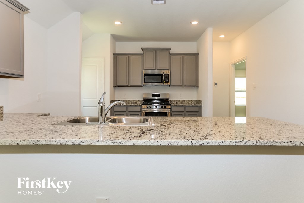 a kitchen with a granite counter top and a sink