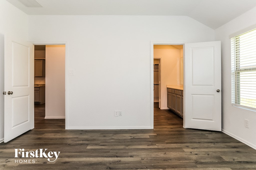a bedroom with two closets and a door to a bathroom
