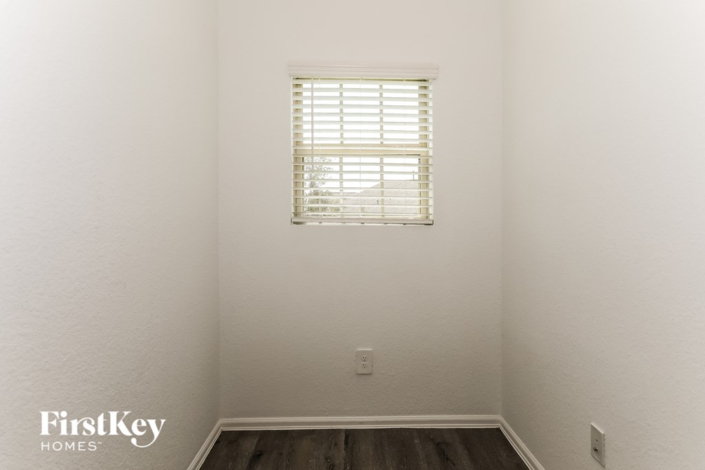 a room with white walls and a window