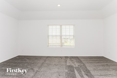 a white room with a window and a cement floor