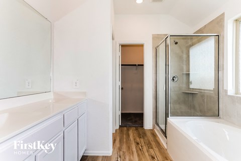 a bathroom with a large white sink and a shower