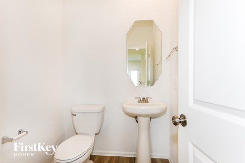a bathroom with a sink and a toilet and a mirror