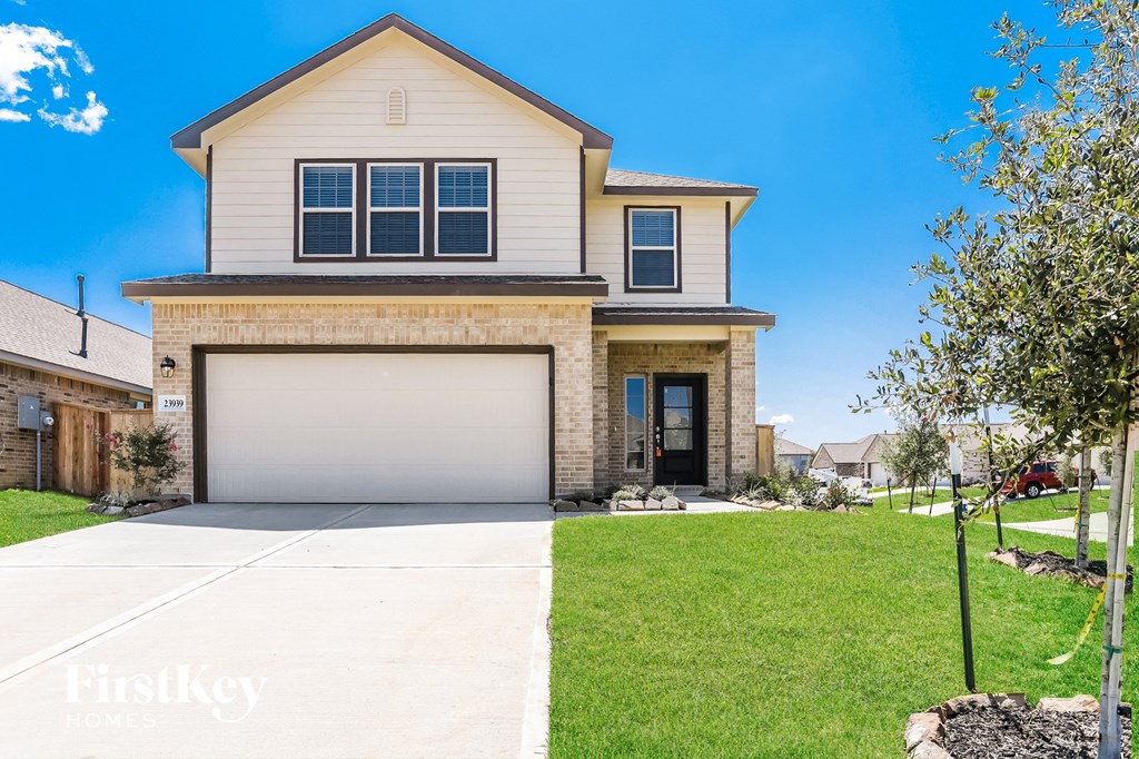 a house with a garage door and a lawn
