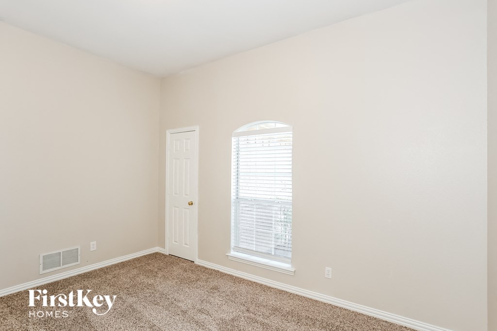 a room with carpet and a window and a door