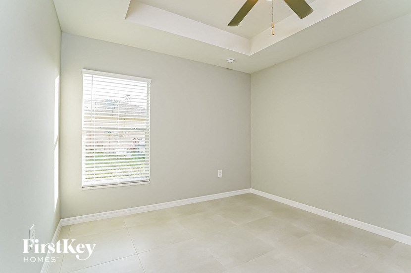 A room with a window and a ceiling fan.
