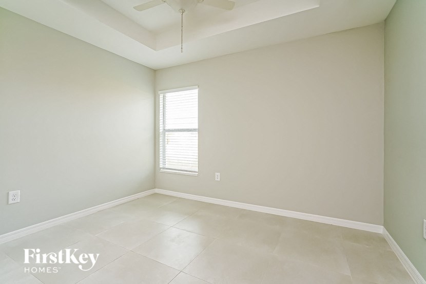 A room with a FirstKey Homes logo on the bottom left corner.