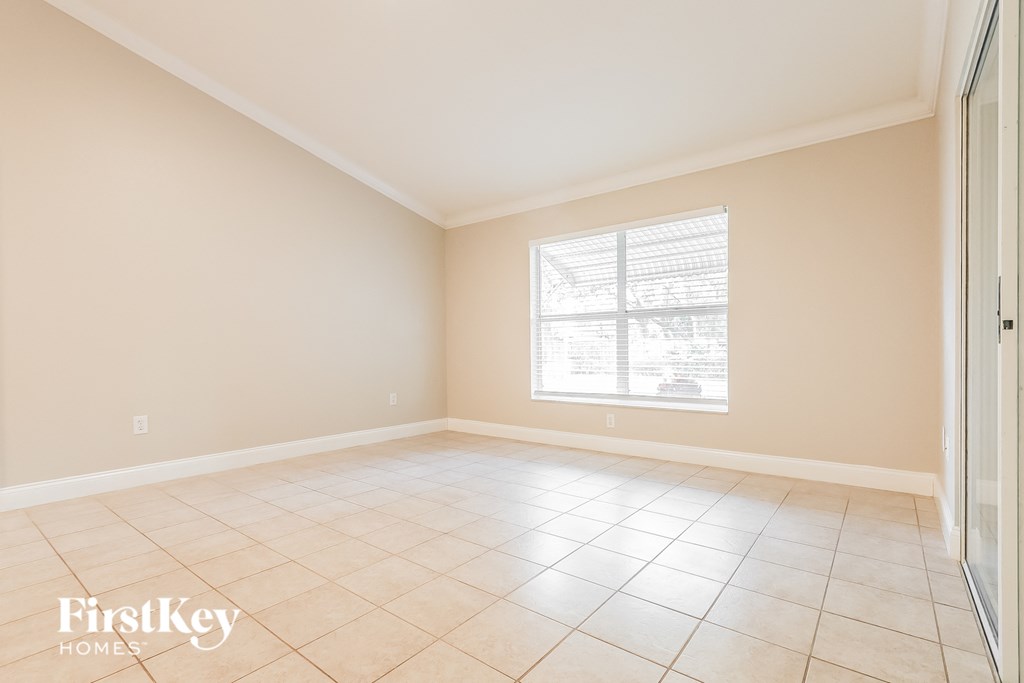 A room with a window and tiled floor.