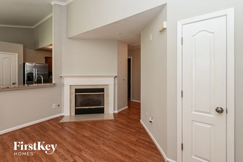 a living room with a fireplace and a white door