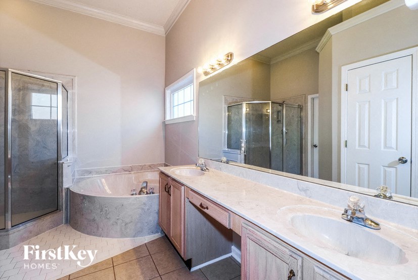 a bathroom with a sink and a tub and a mirror
