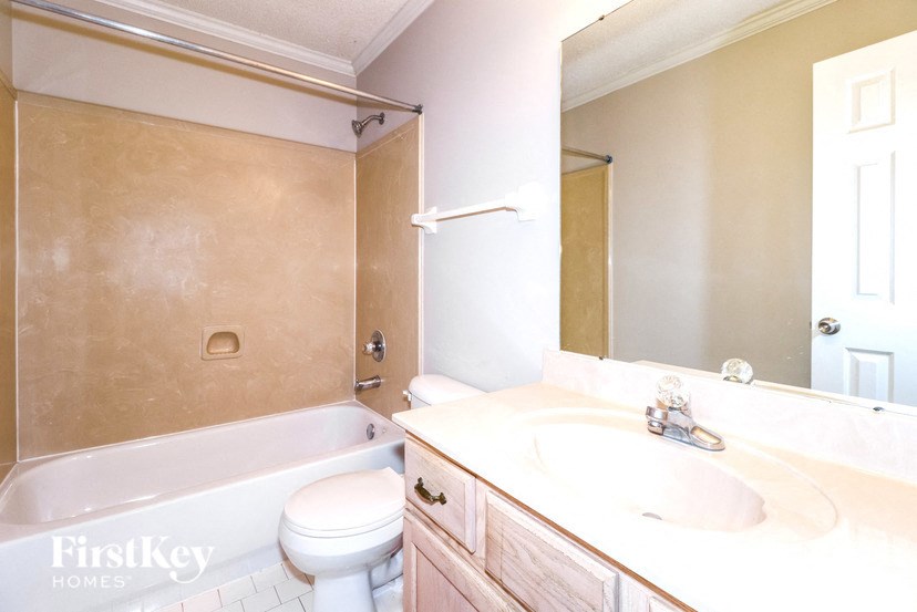 a bathroom with a sink and a toilet and a tub