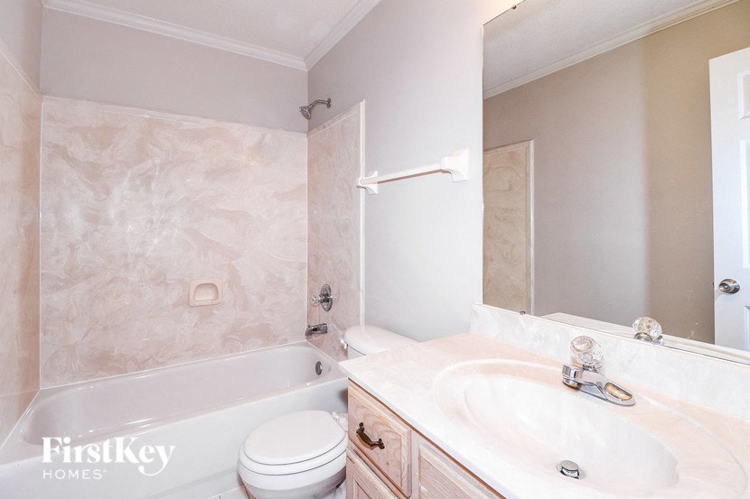 a bathroom with a sink toilet and a bath tub