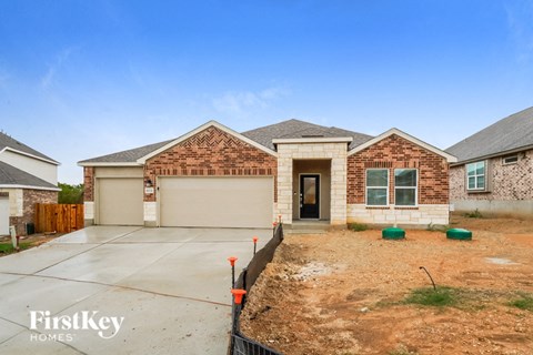 a new brick house with a driveway and a garage door