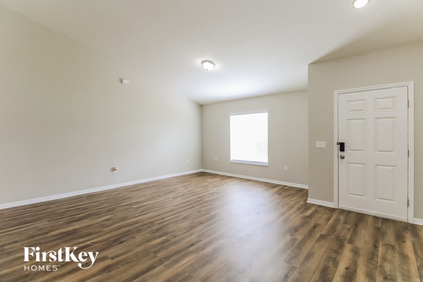 A room with wooden floors and a white door.