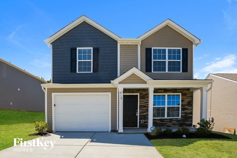 a blue house with a white garage door in front of it