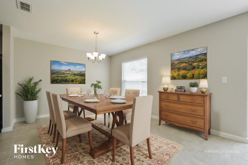 A dining room with a wooden table and chairs.