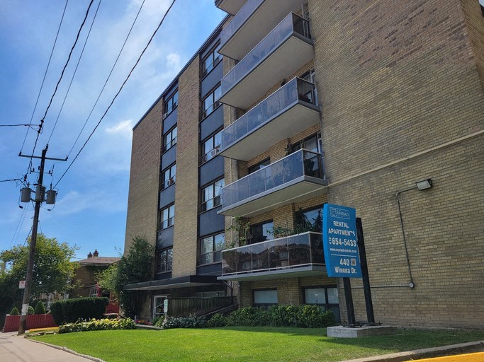a brick apartment building with a street sign in front of it