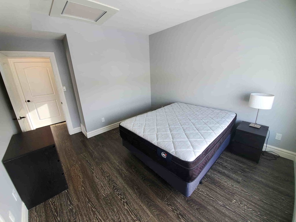 a bedroom with a bed and a dresser