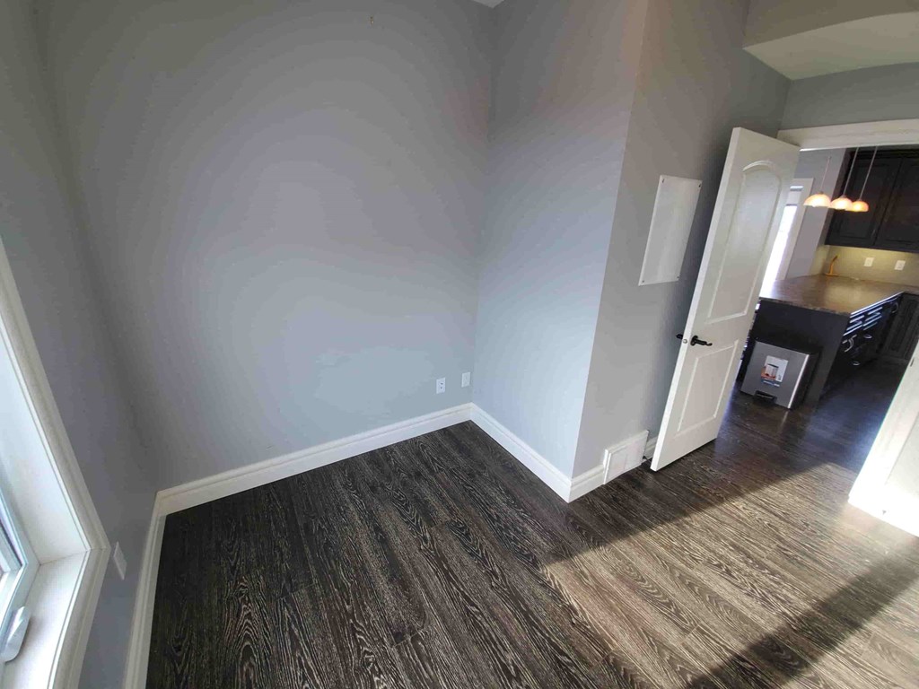 a living room with a hard wood floor and blue walls