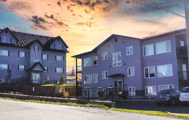 a purple house with a sunset behind it
