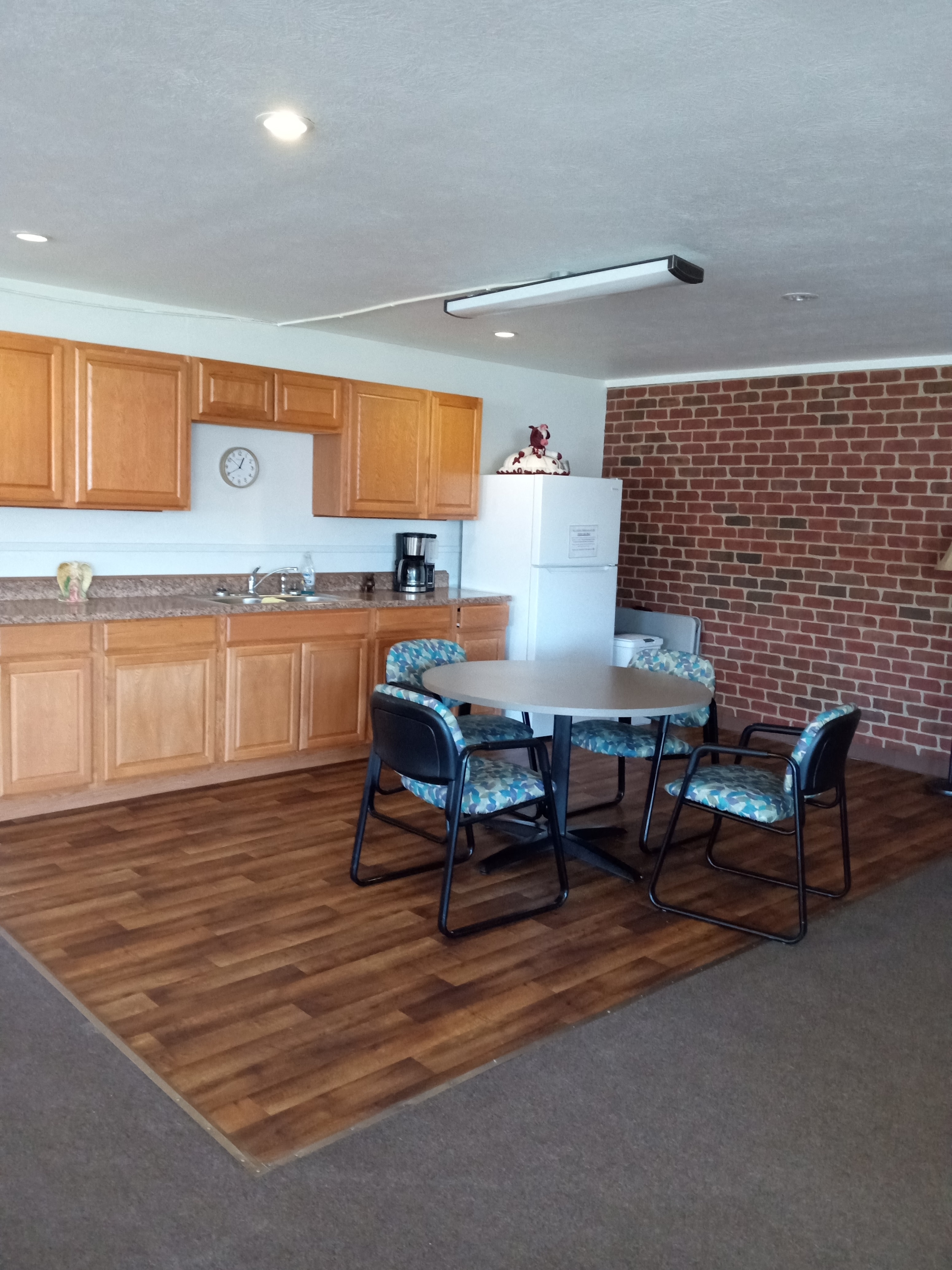 a kitchen with a dining table and a brick wall