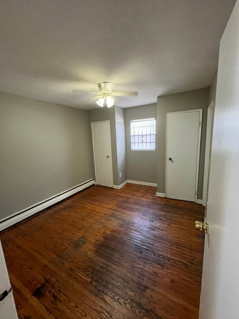 A room with wooden floors and white walls.