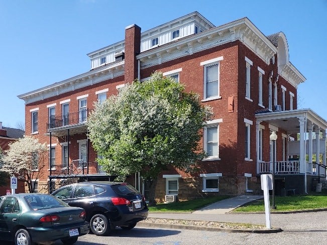 a brick building with cars parked in front of it