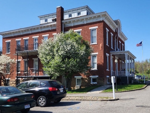 a large brick building with cars parked in front of it