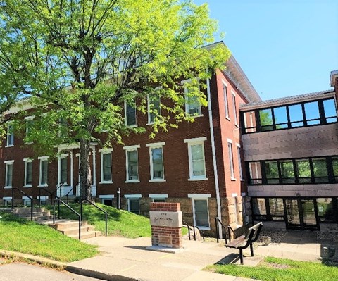 a brick building with a bench in front of it
