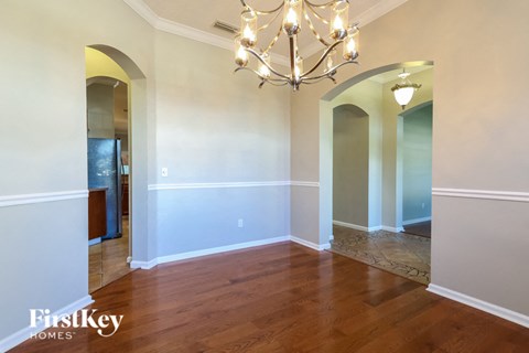 a empty dining room with a chandelier