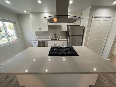 A modern kitchen with a large island in the center.