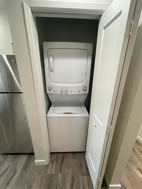 A white oven and microwave are installed in a kitchen.