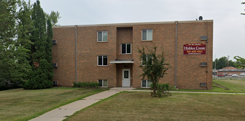 a brick building with a sidewalk in front of it