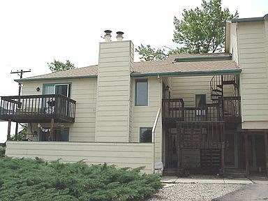 A house with a balcony and a staircase leading to the second floor.