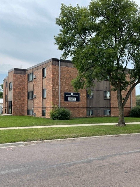 a brick building with a tree in front of it