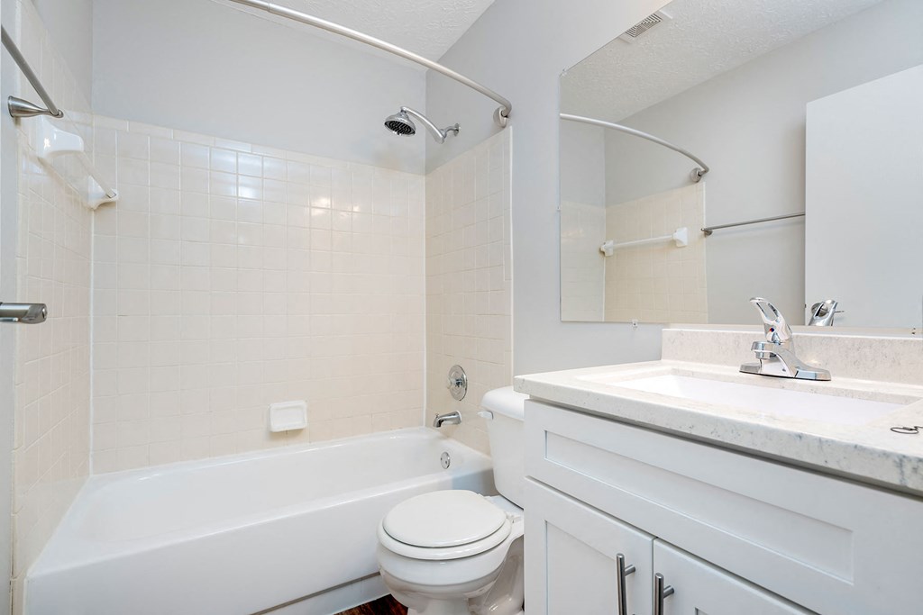 a bathroom with a sink toilet and bath tub