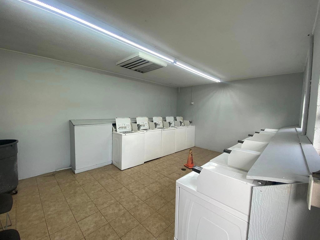 an empty laundry room with washers and machines