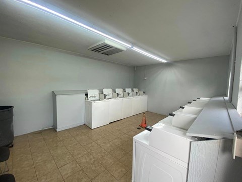 an empty laundry room with washers and machines