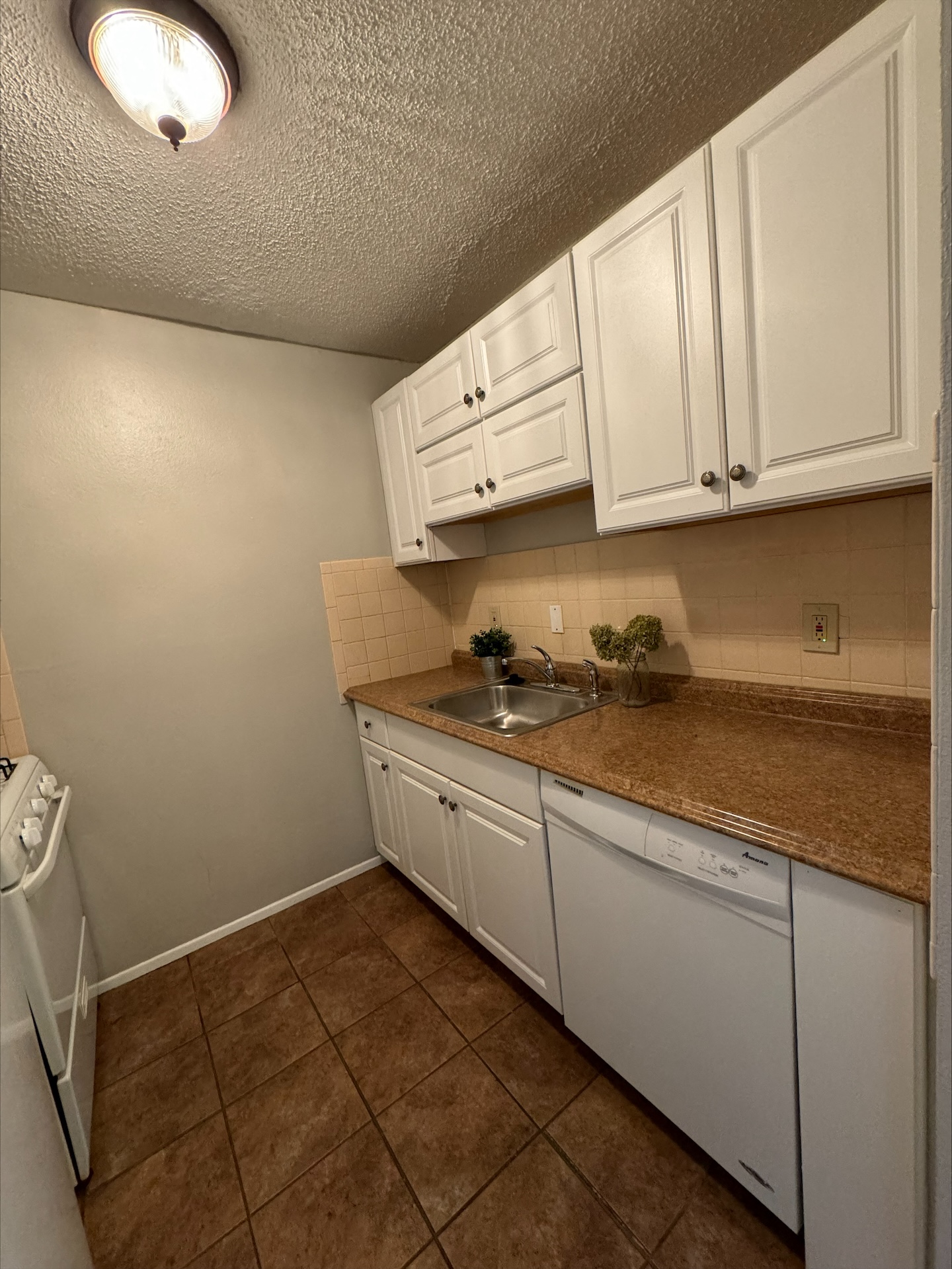 a kitchen with white cabinets and a sink