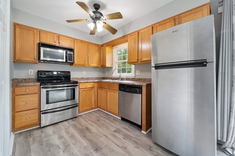 A kitchen with wooden cabinets and stainless steel appliances.
