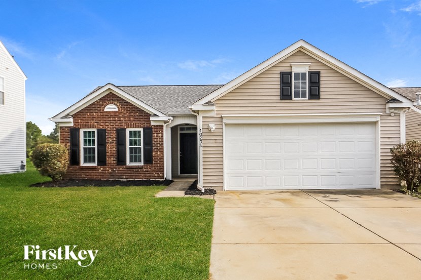 a house with a white garage door and a lawn