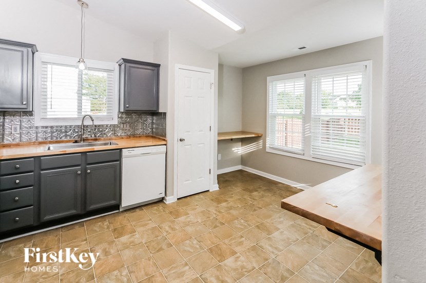 an empty kitchen with a sink and a window